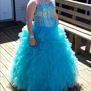 A teal blue prom dress with gems on the bodice.